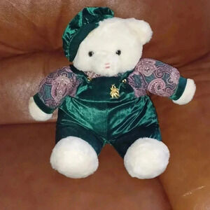 Stuffed bear toy in green hat and  pants